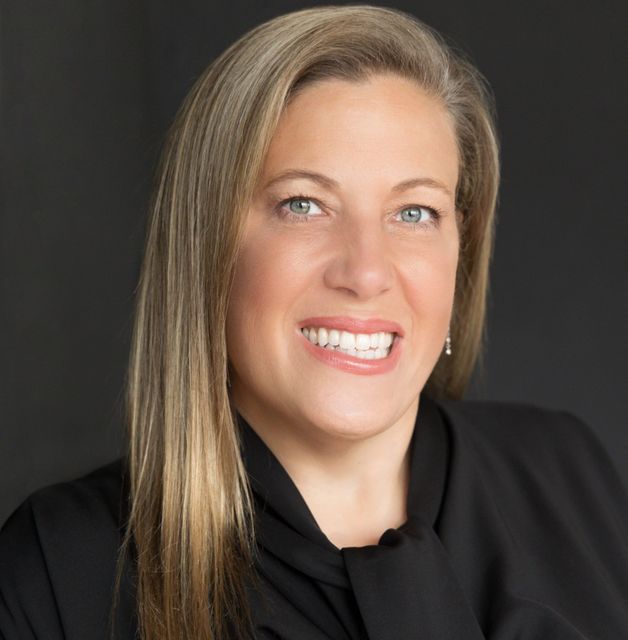 DEB CURRY Profile Picture - a woman in a black shirt and tie is smiling for the camera .