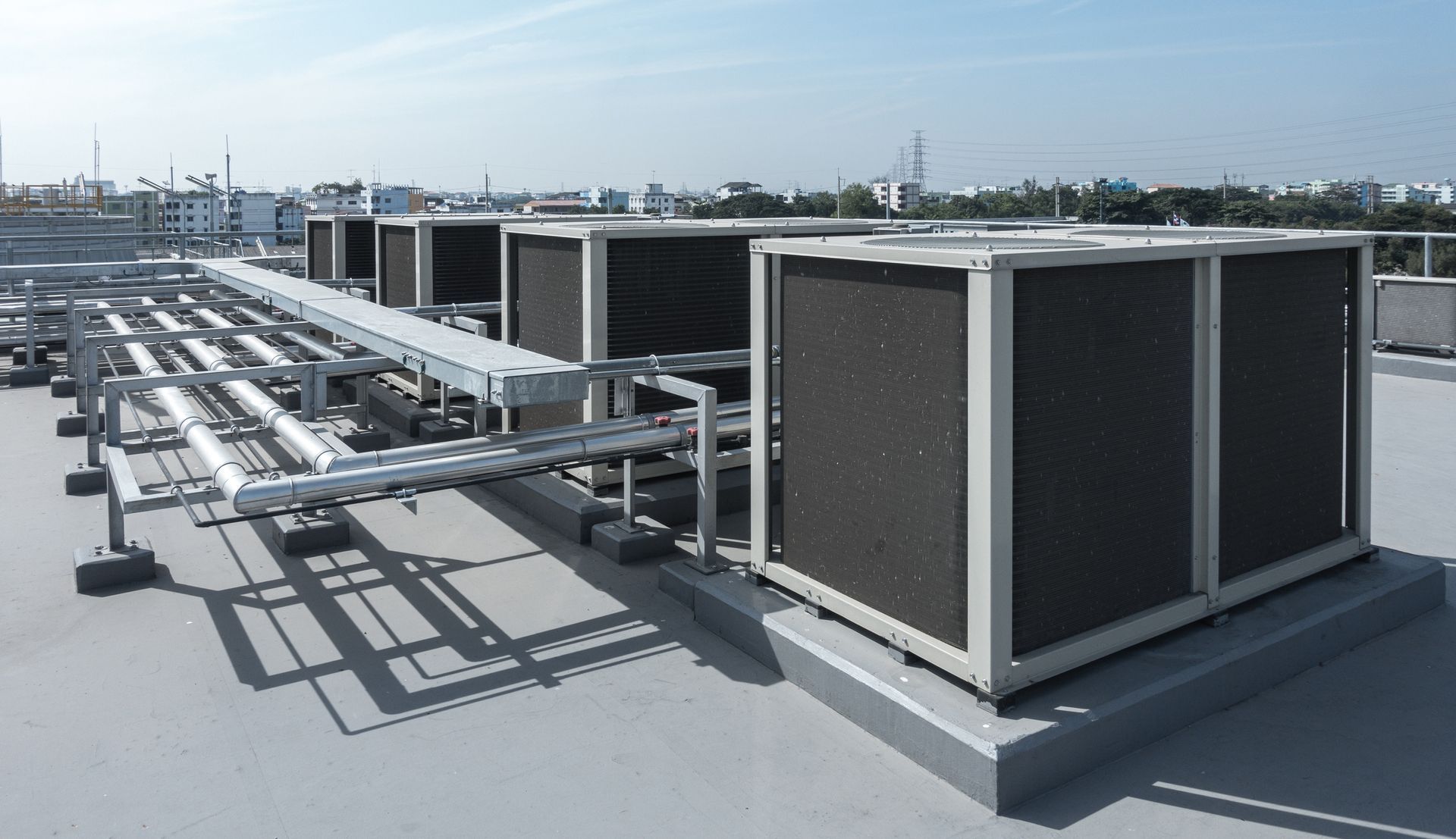 Air compressor on rooftop of industrial factory serviced by Pride Mechanical Air Conditioning, 
