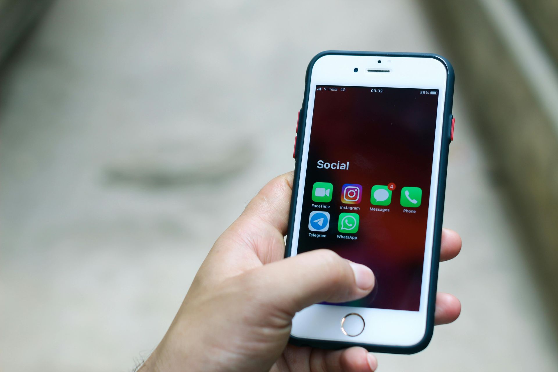 A person is holding a cell phone in their hand.
