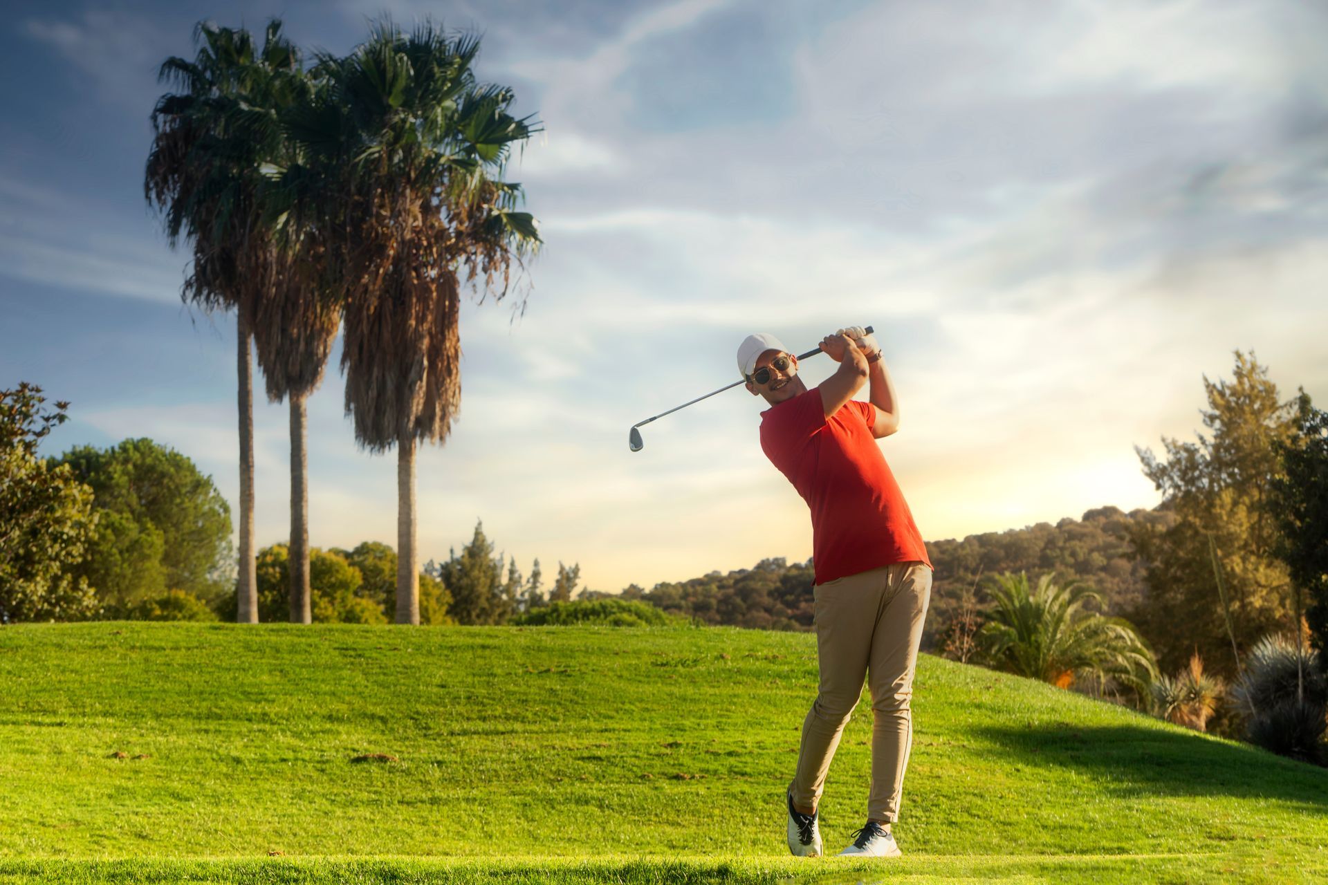 A group of people are playing golf on a golf course.