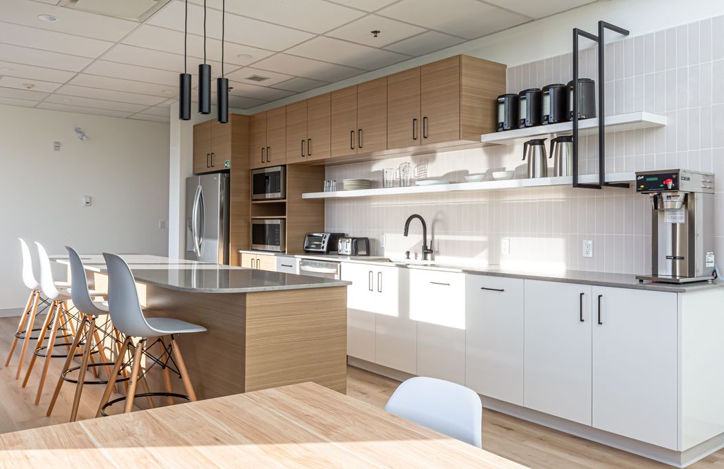 A kitchen with a table and chairs in it.
