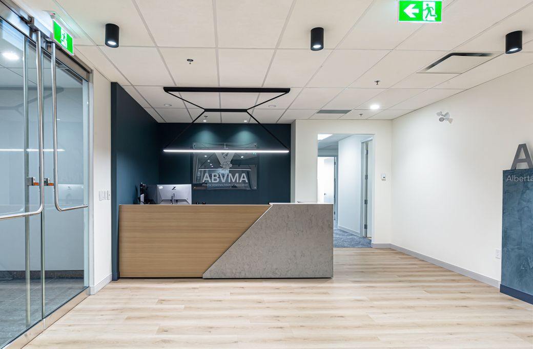 A reception area in an office building with a wooden counter.