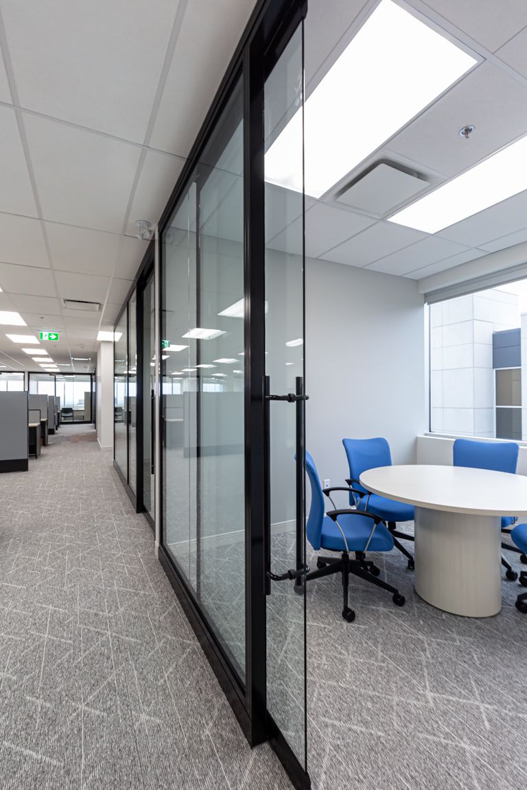 A conference room with a table and chairs in an office building.