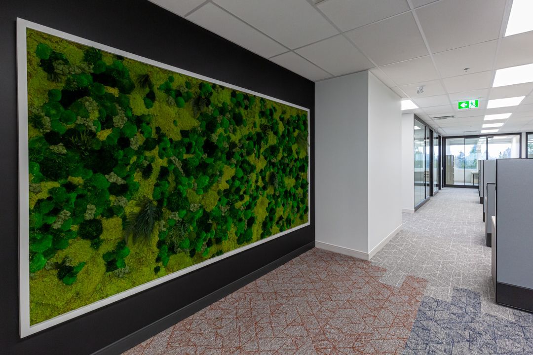 There is a large picture of moss on the wall in the hallway.