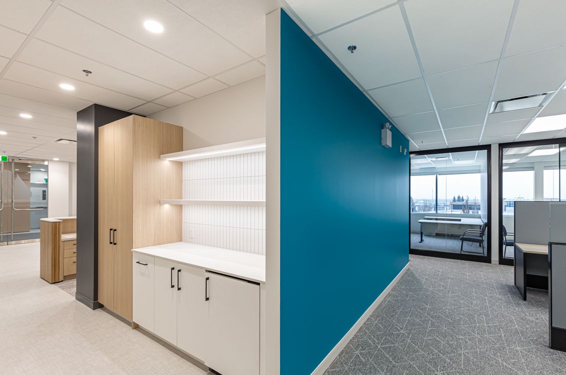 A picture of a kitchen and an office with blue walls.