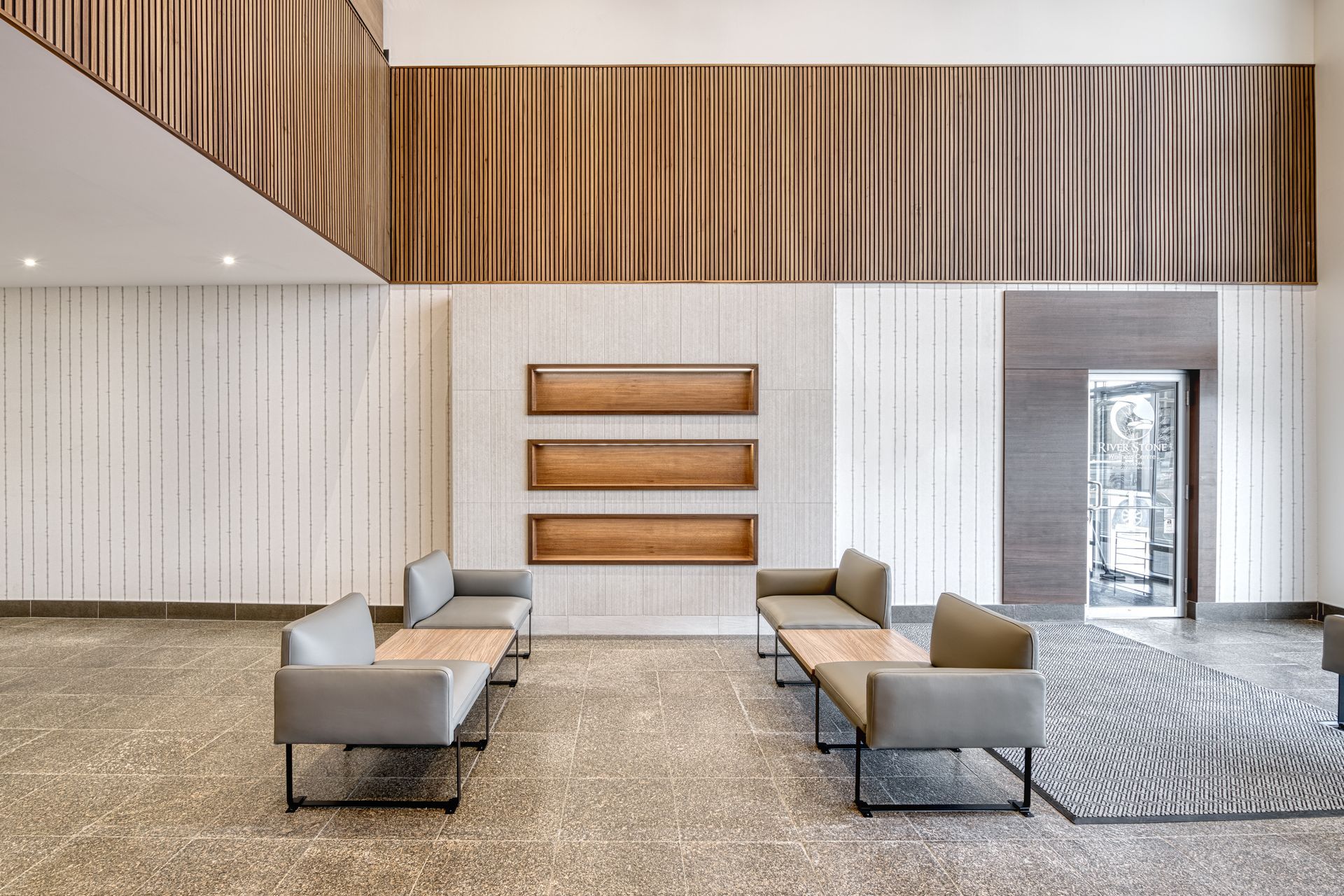 A large lobby with a lot of furniture in it.