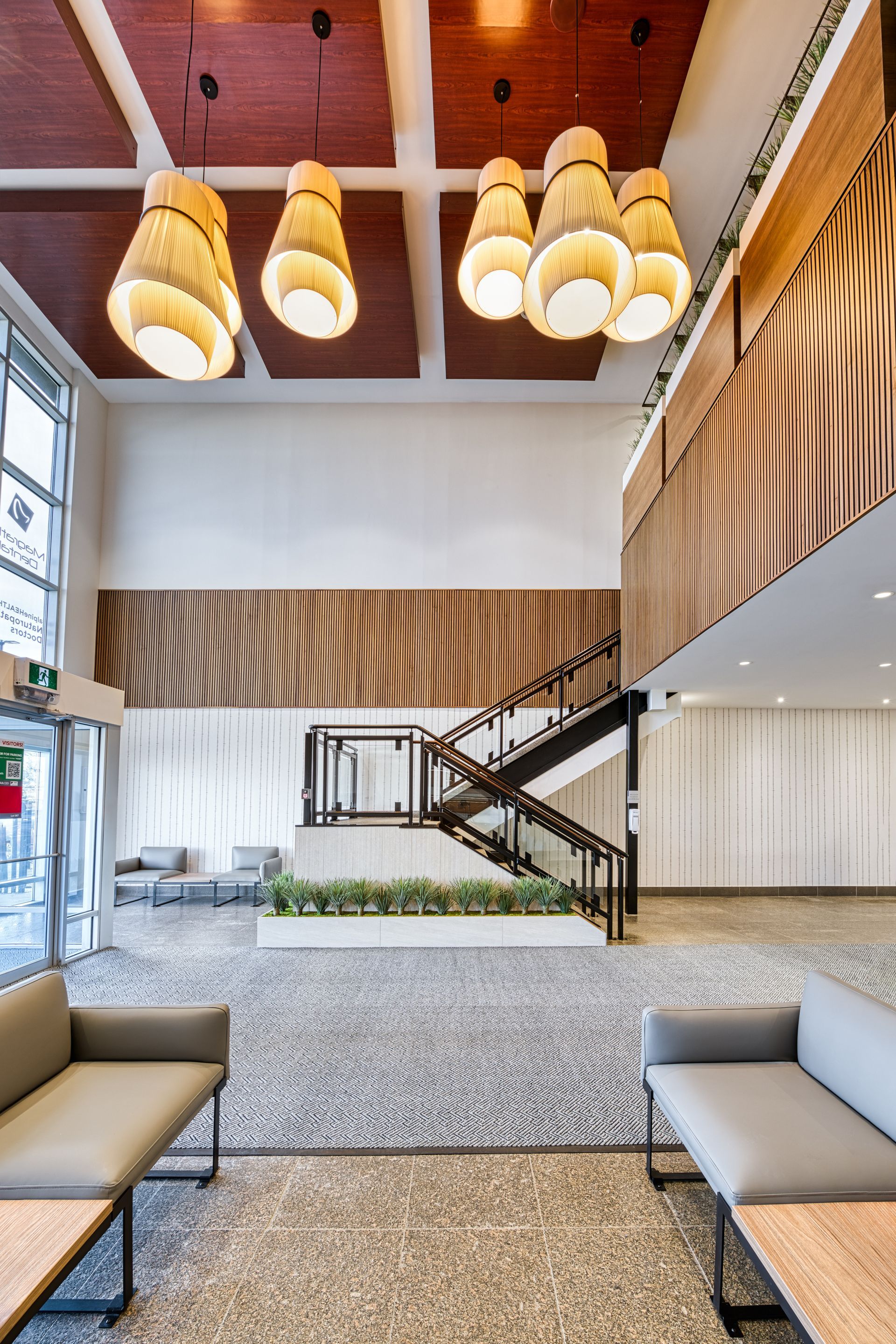 A large lobby with a staircase and a couch.