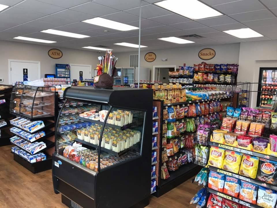 Interior of a convenience store: snacks, drinks, and bakery items on display.