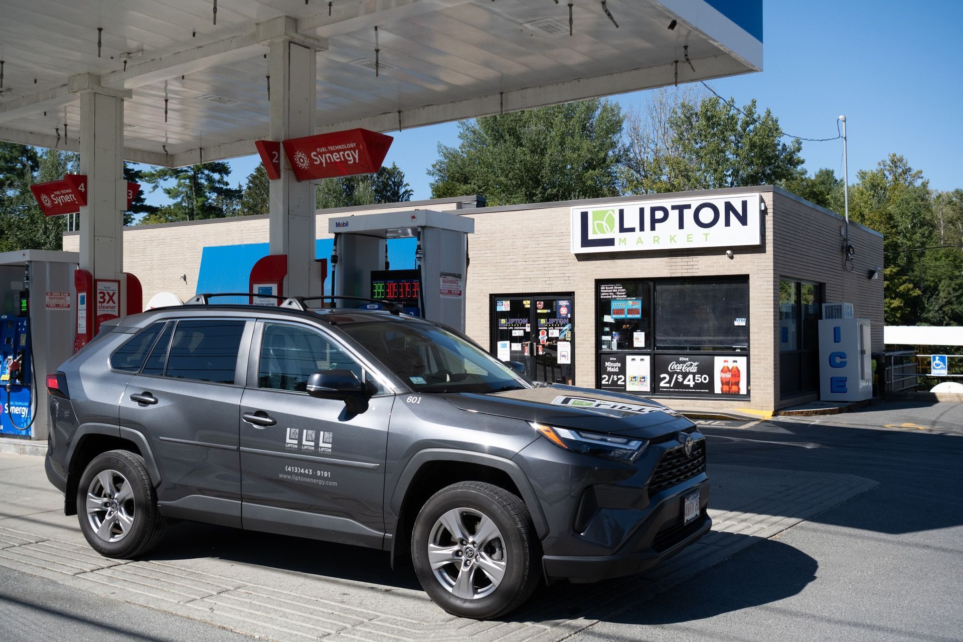 Gray SUV parked at a gas station with a 