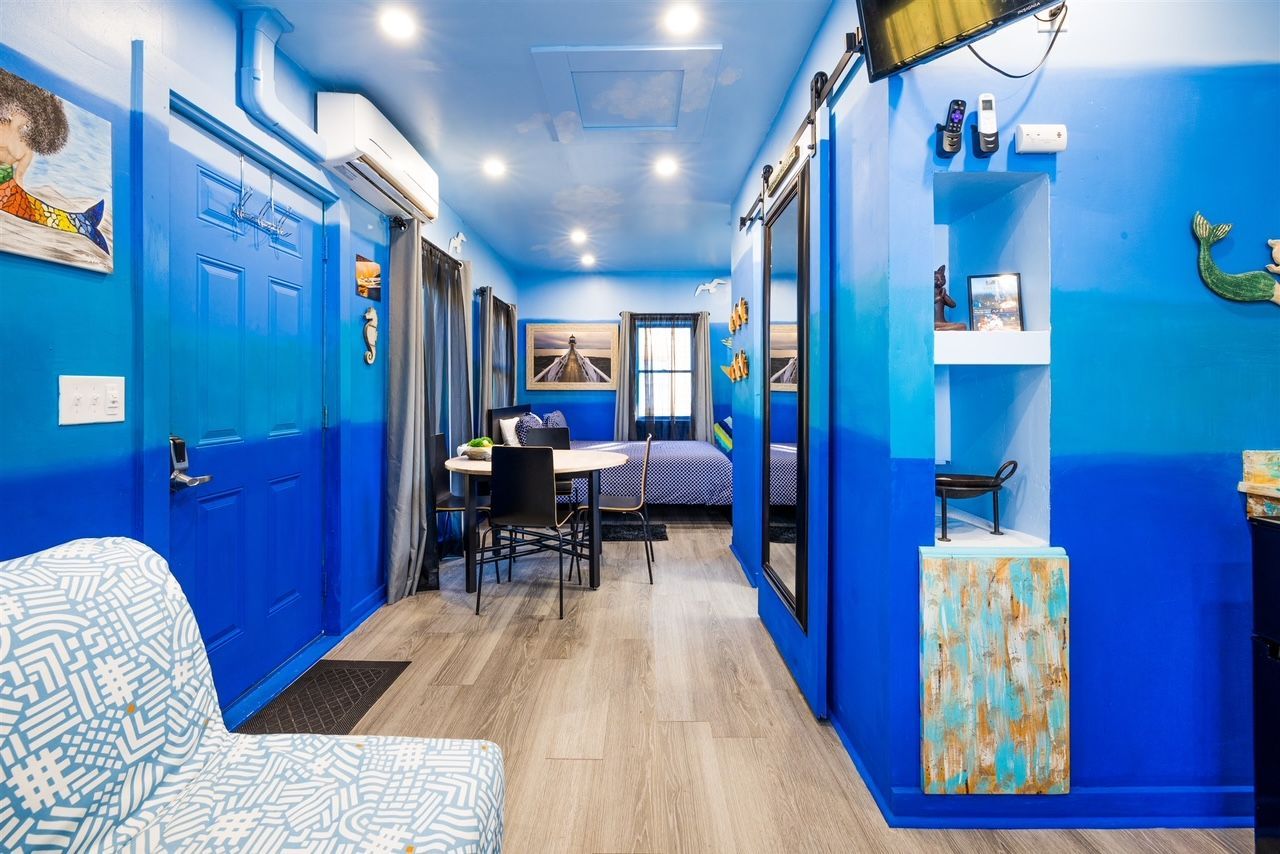 a living room with blue walls and a couch .