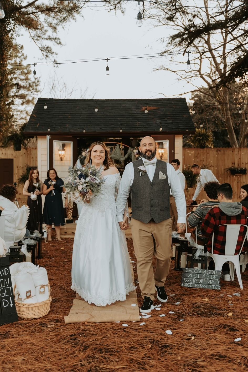 a bride and groom are walking down the aisle at their wedding holding hands .