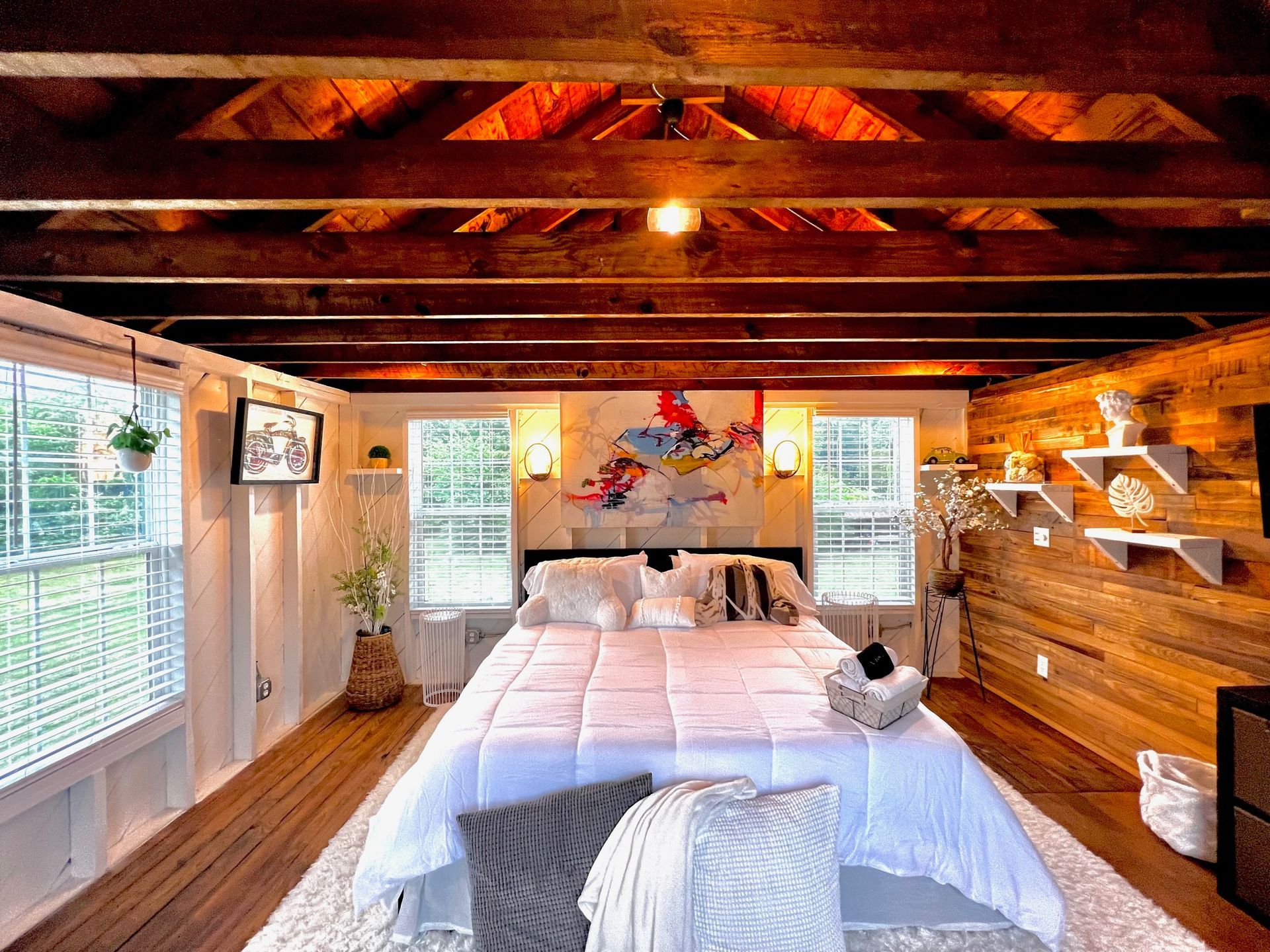 a bedroom with a large bed and a wooden ceiling