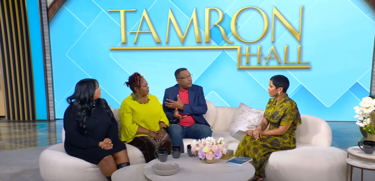A group of people are sitting on a couch on a television show.