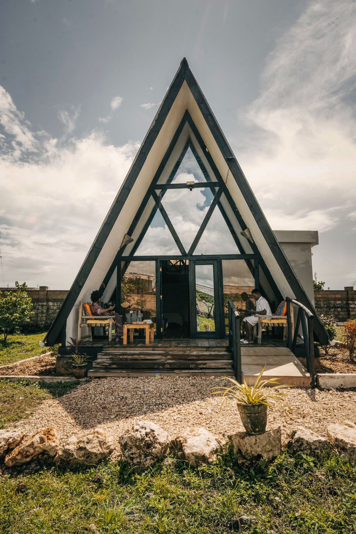 A small wooden house with stairs leading up to it.