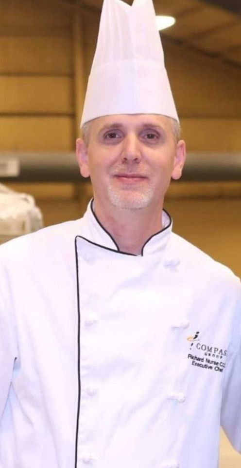 Our  chef wearing a white hat and a white jacket