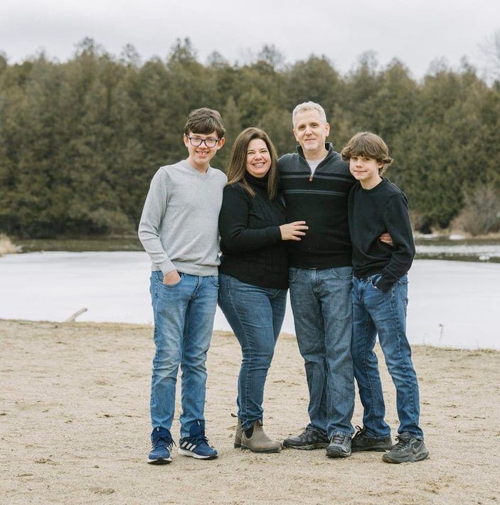 The Nurse Family standing next to each other on a beach.