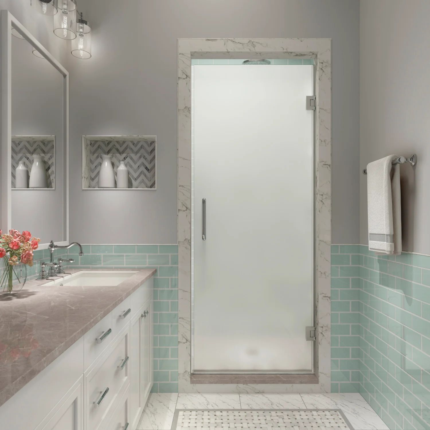 A stylish bathroom with light aqua subway tile featuring a marble-trimmed frosted glass shower enclosure door beside a white vanity with marble countertops