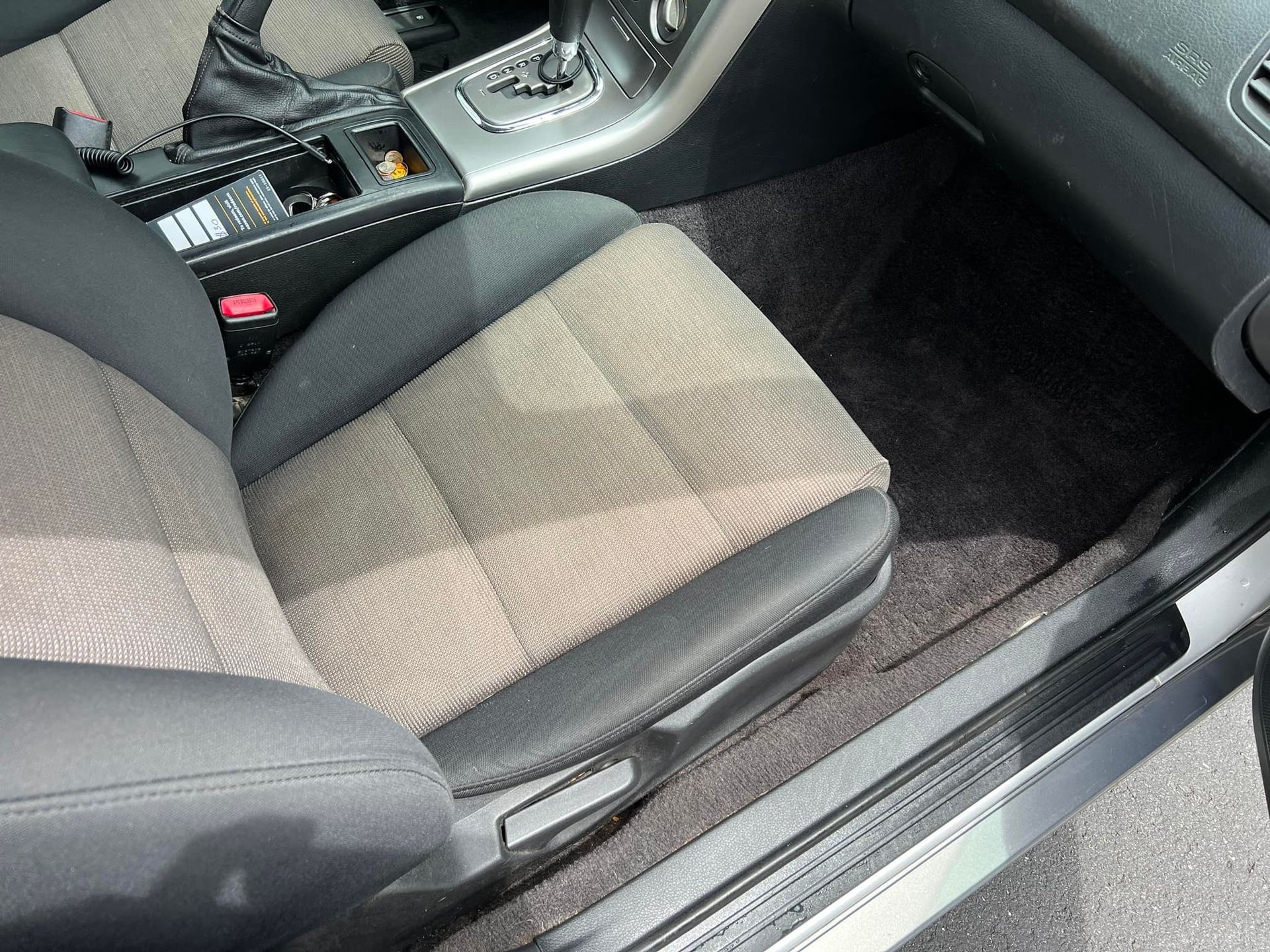Car front passenger seat and center console with gray fabric upholstery and black trim