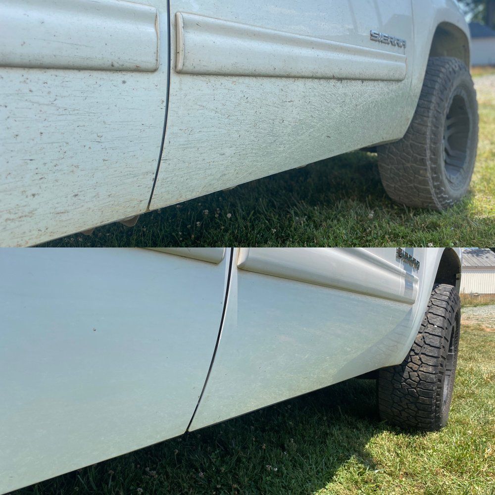 Before-and-after view of a white truck’s lower side panel after cleaning, showing dirt removed.