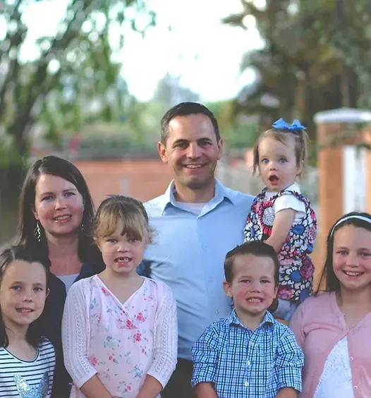 A group of children posing for a picture with their parents