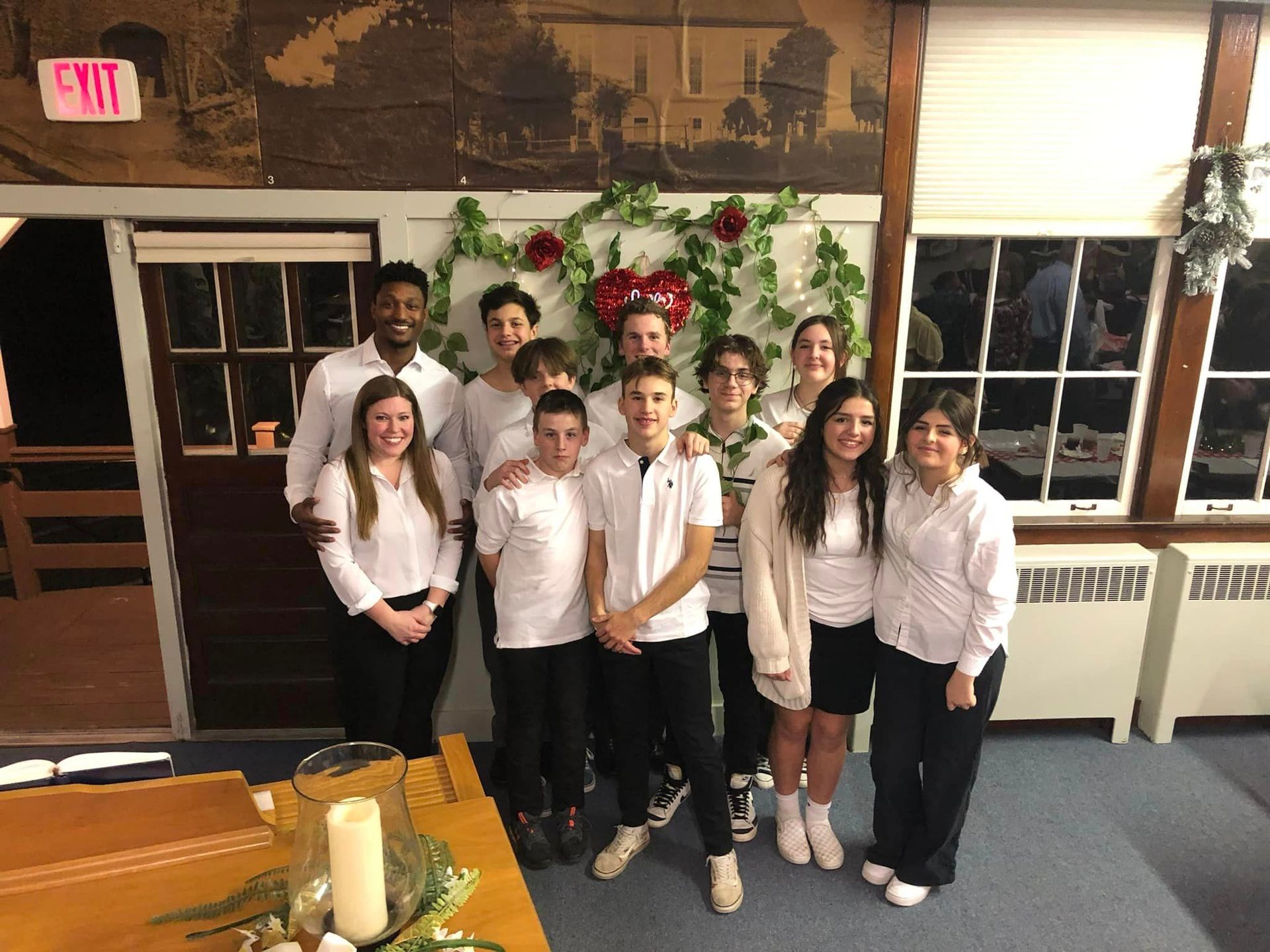 A group of young people are posing for a picture in a room.