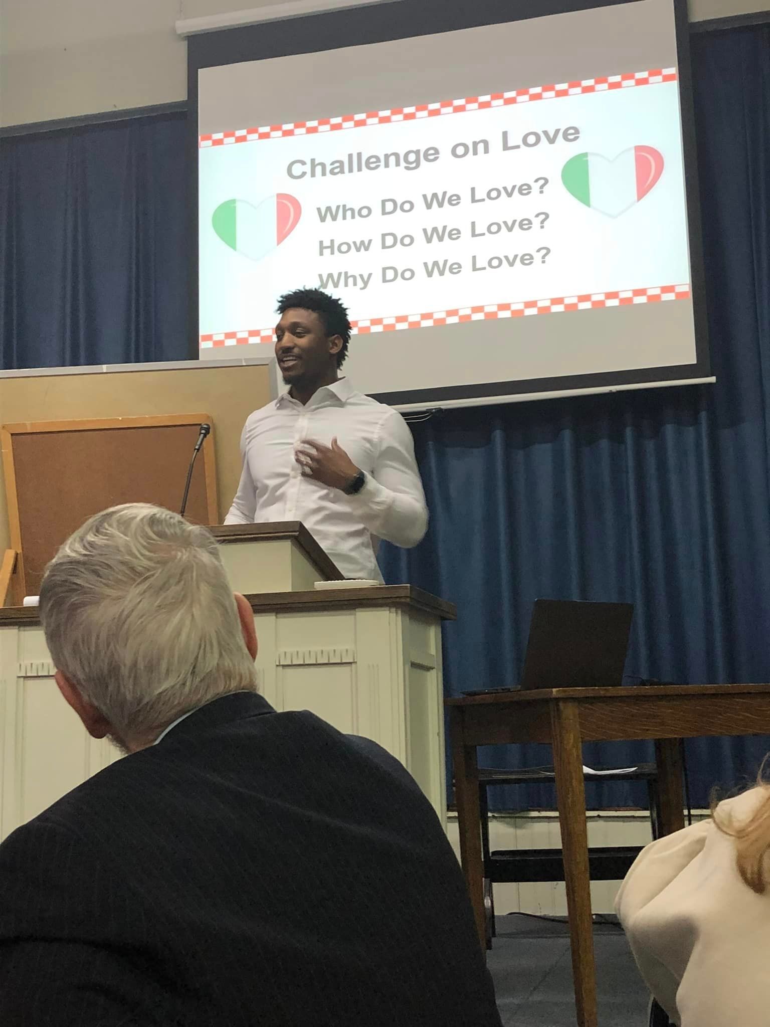 A man is giving a presentation about challenge on love