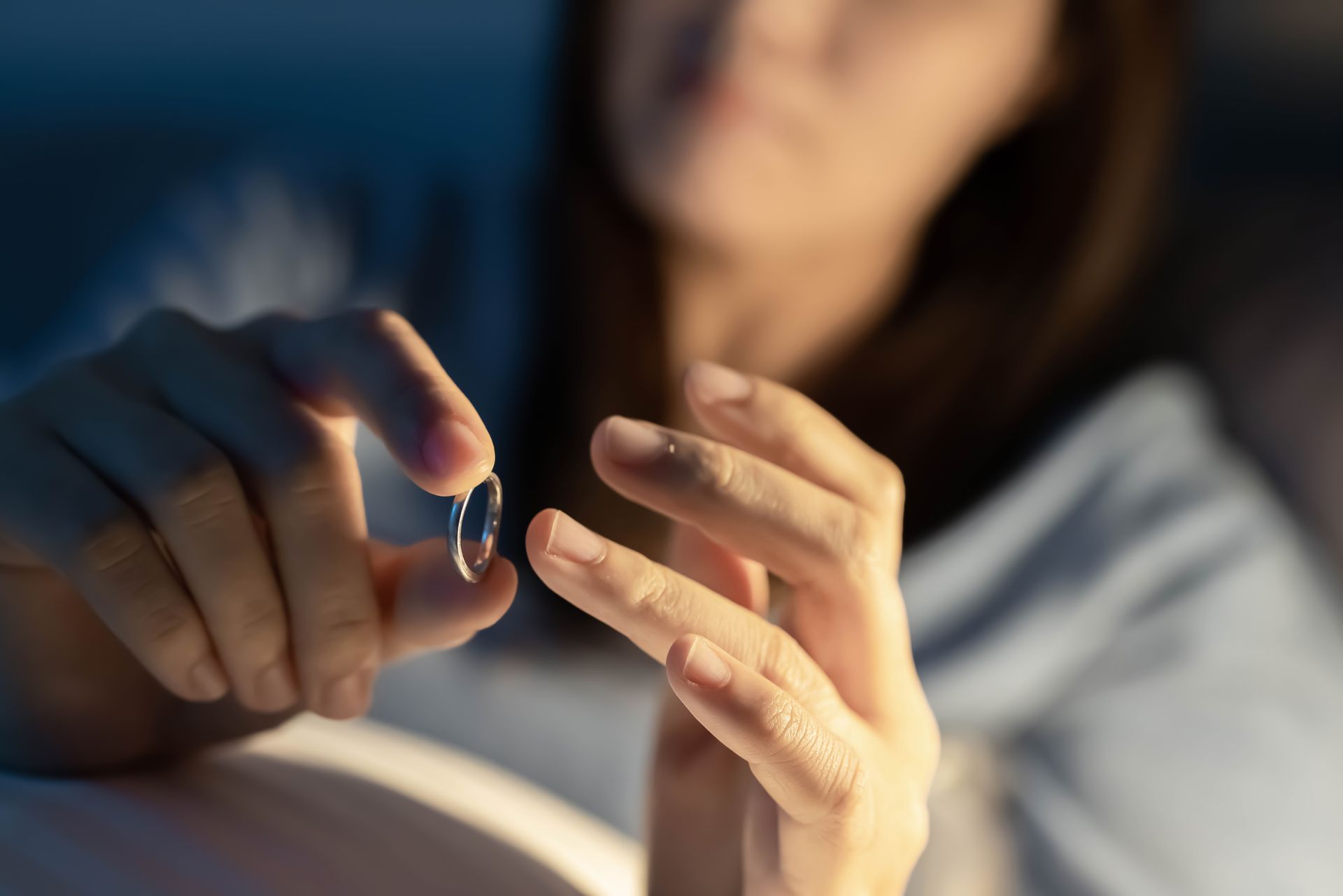Person in bed holding a pill, ready to take it at night.