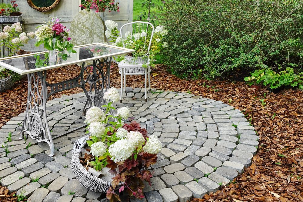 Ornamental Decorative Backyard Patio Exterior With Iron Table — D-Scapes Landscaping Services Pty Ltd in Hallidays Point, NSW