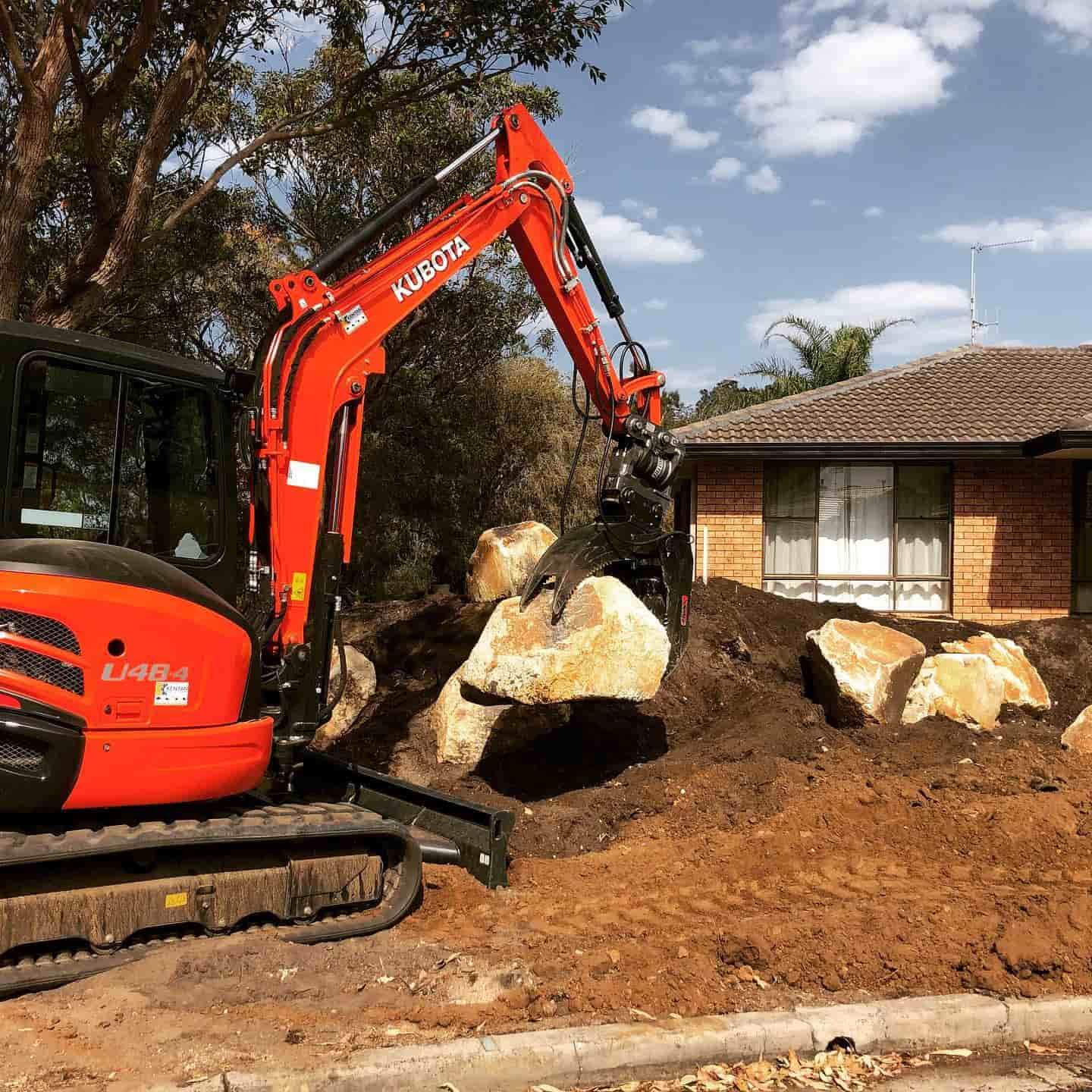 Lifting a Huge Stone — D-Scapes Landscaping Services Pty Ltd in Forster, NSW
