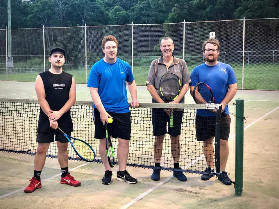 Four Men Standing at a Tennis Net, Holding Rackets — Topspin Tennis Newcastle in Adamstown, NSW