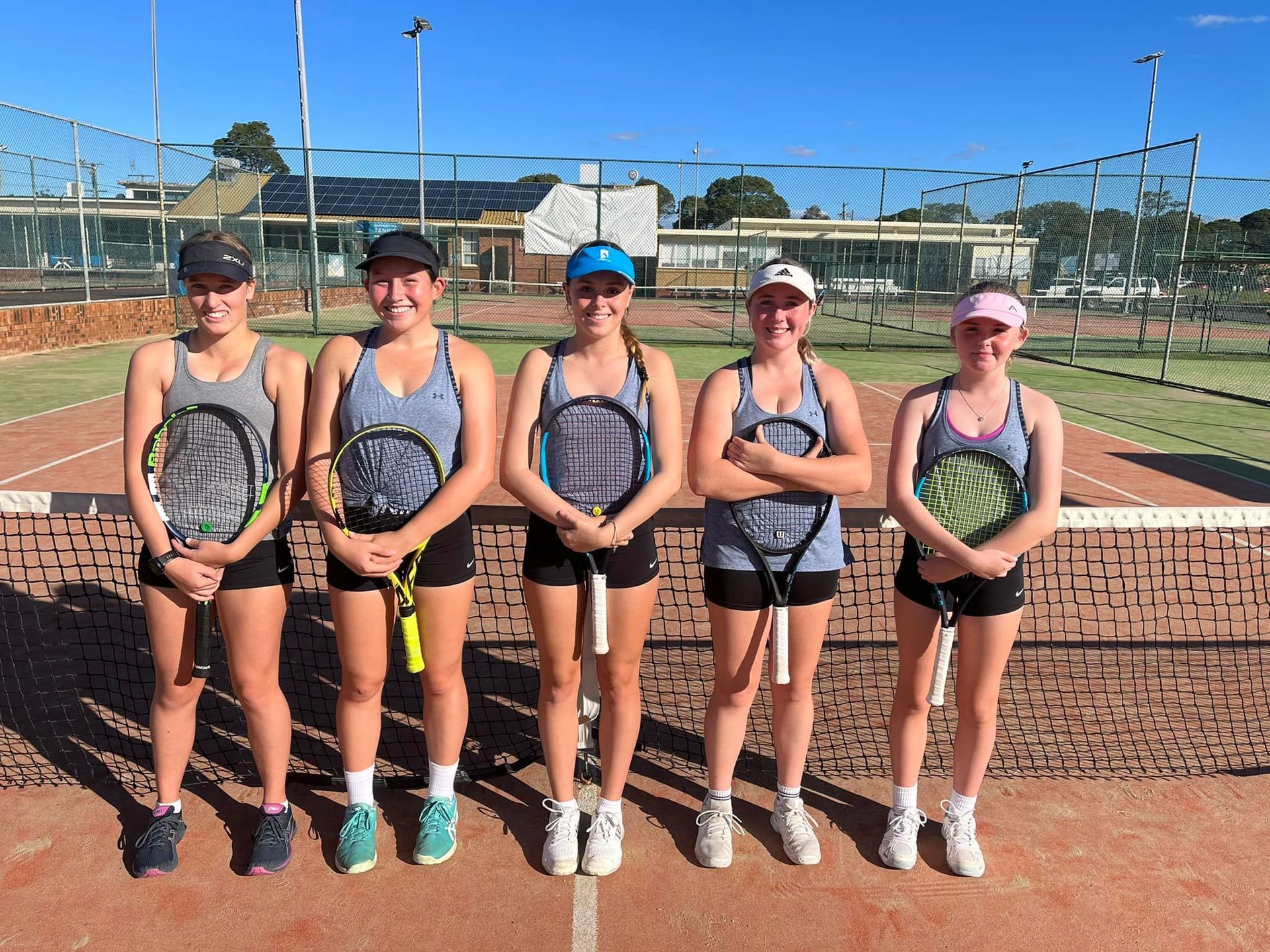 A Group of Men Standing on a Tennis Court Holding Tennis Rackets — Topspin Tennis Newcastle in Lambton, NSW