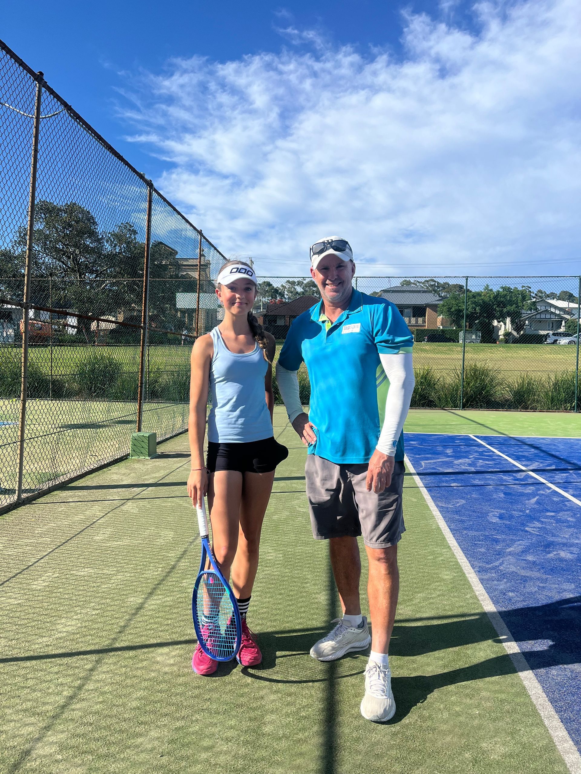 Woman With Tennis Racket and Man Stand on Court — Topspin Tennis Newcastle in Adamstown, NSW