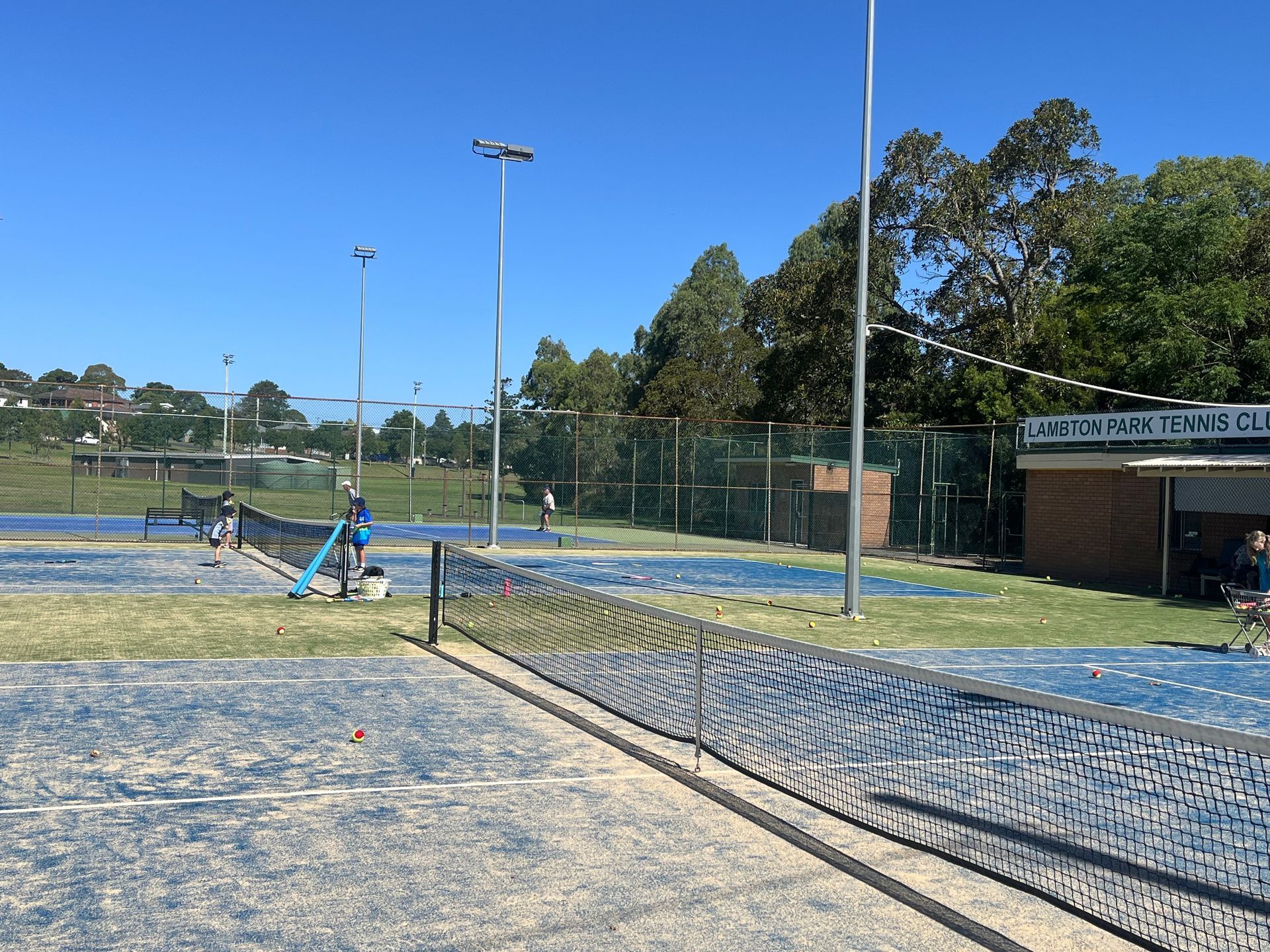 Tennis Players on Blue Courts at Lawson Park Tennis Club — Topspin Tennis Newcastle in Lambton, NSW