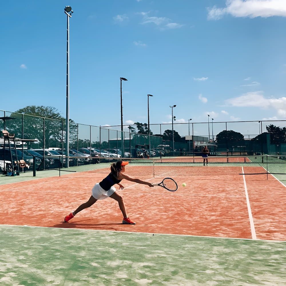 A Woman is Playing Tennis on a Court  — Topspin Tennis Newcastle in Lambton, NSW