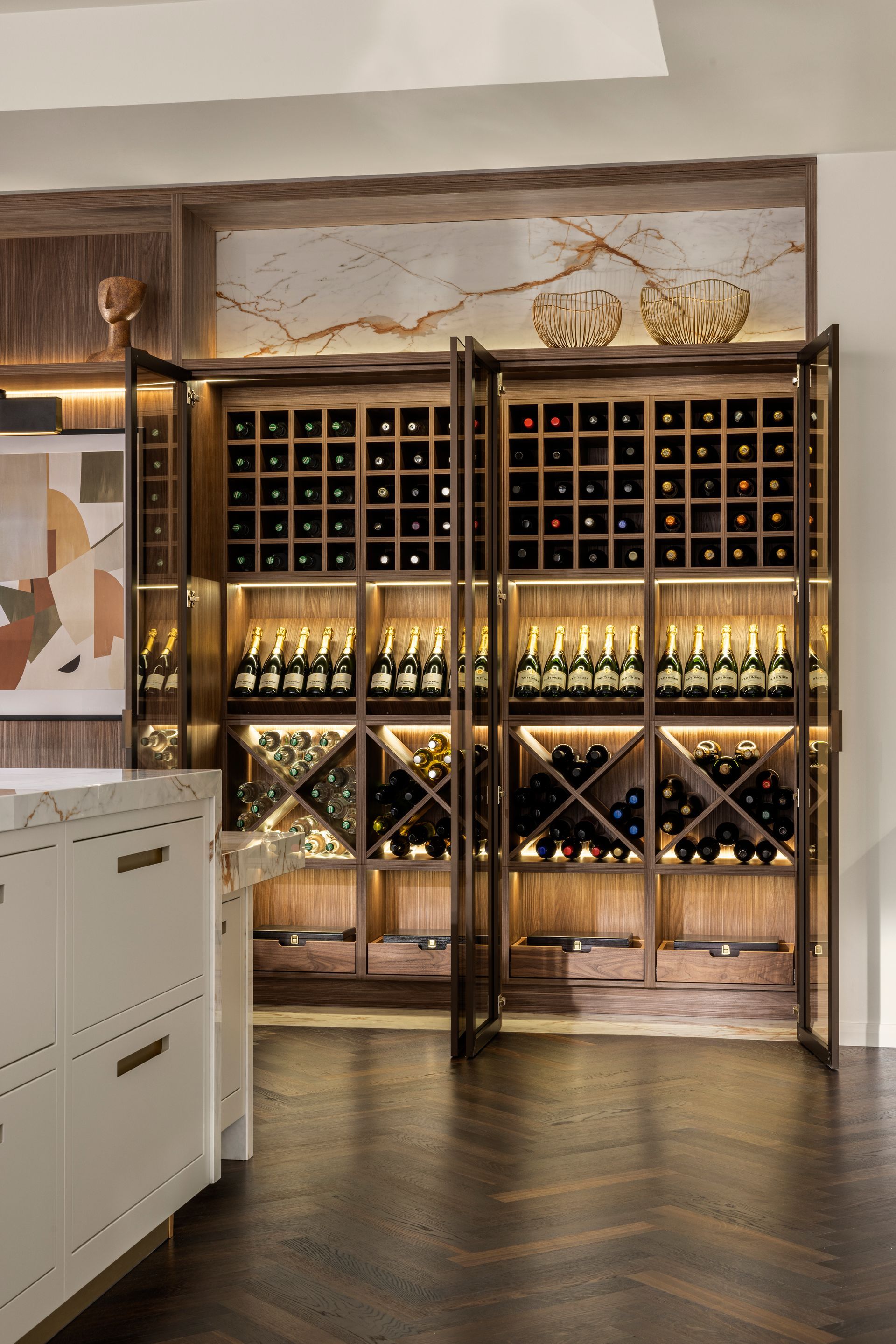 A modern, built-in wooden wine rack with glass doors, featuring LED-lit bottle shelves and diamond-shaped storage.