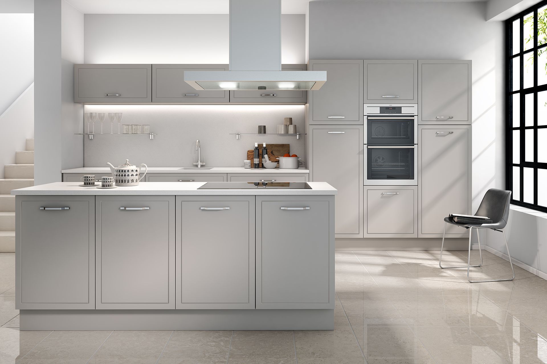 A modern, monochromatic grey kitchen featuring a central island, stainless steel appliances, and large windows.