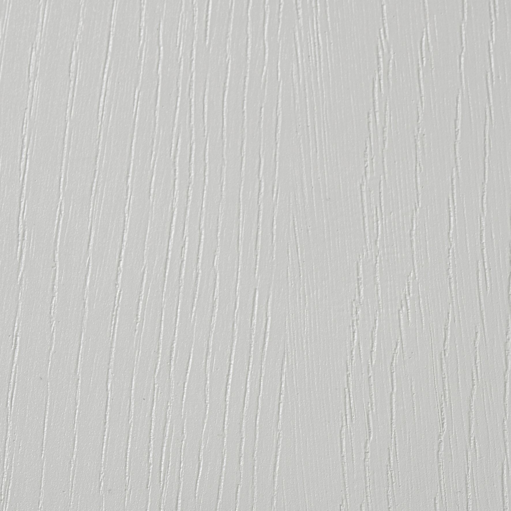 A close-up view of a light gray surface with a vertical wood grain texture.