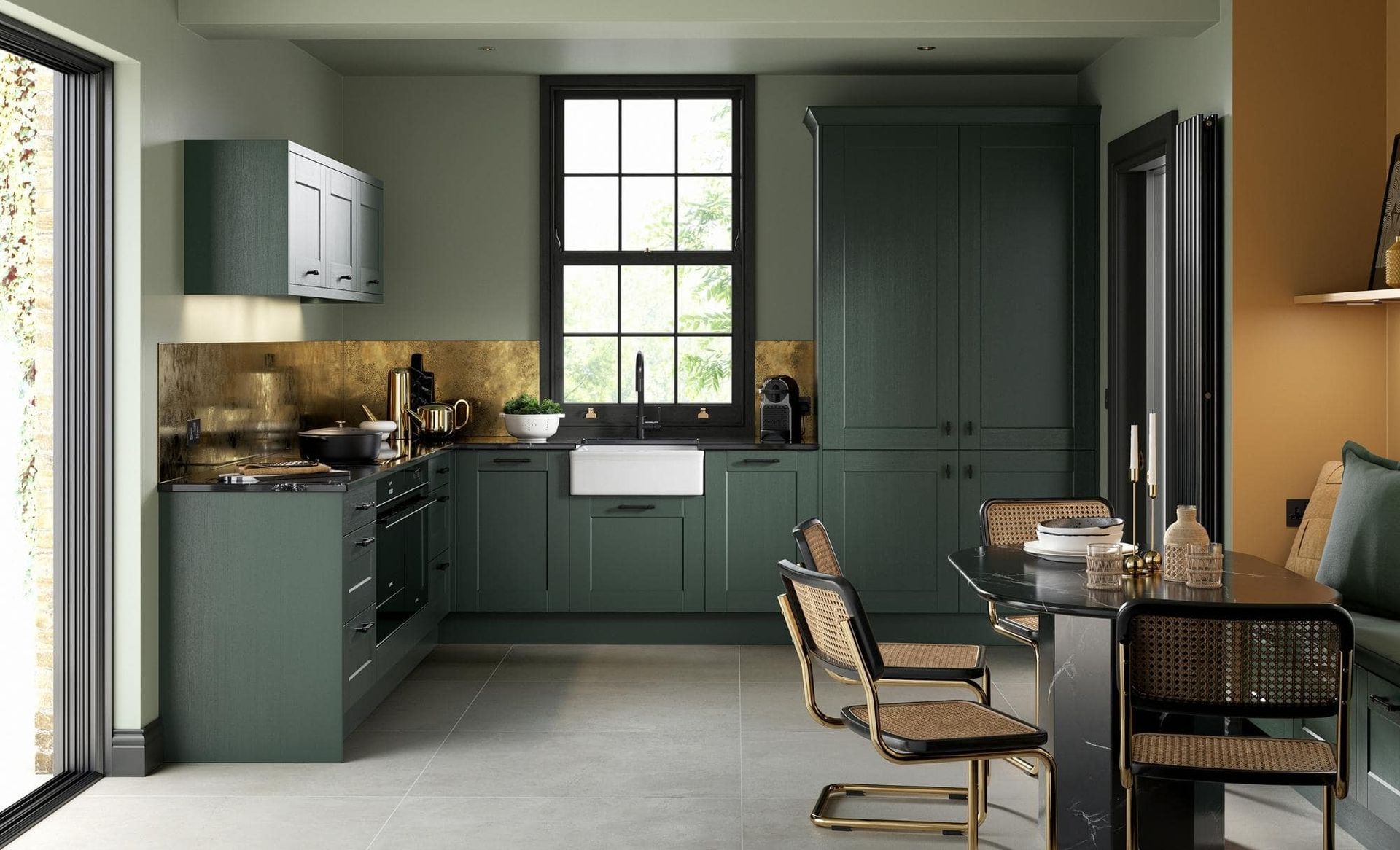 A modern kitchen featuring matte dark green cabinets, a white farmhouse sink, black hardware, and a dining area.