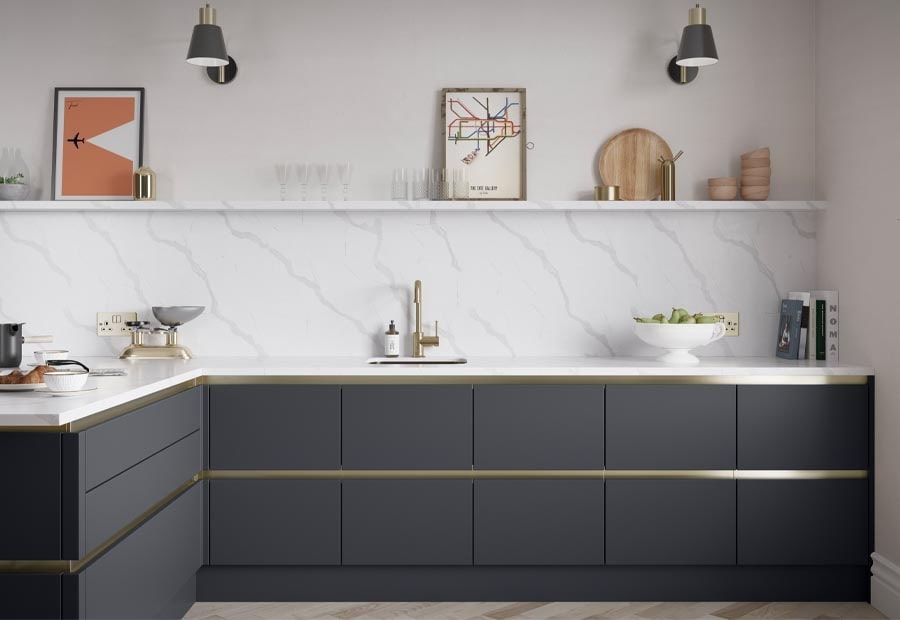 Modern kitchen with dark grey cabinetry, brass handle details, a white marble countertop, and a floating shelf.