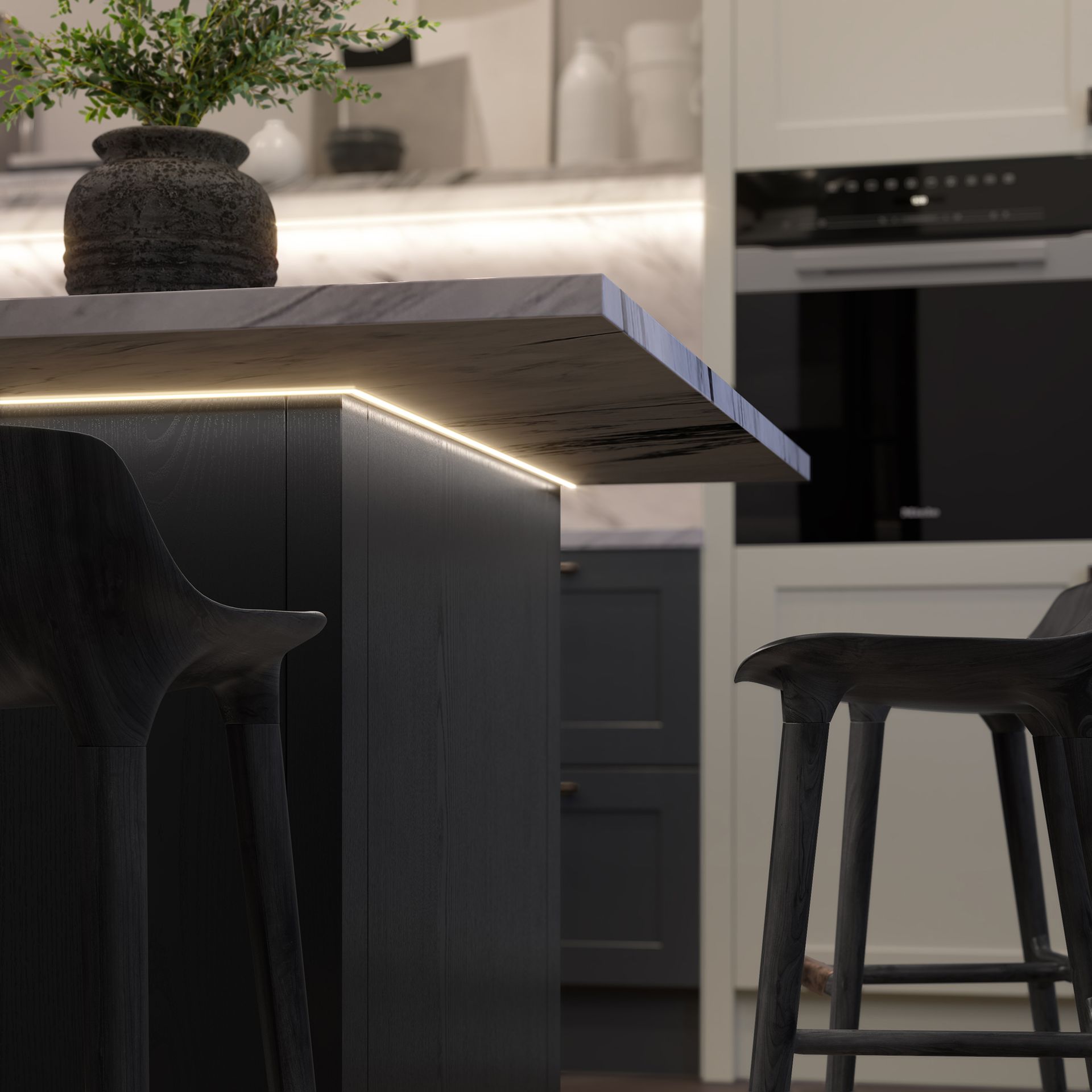 Modern kitchen with a marble island, black stools, and built-in oven in the background
