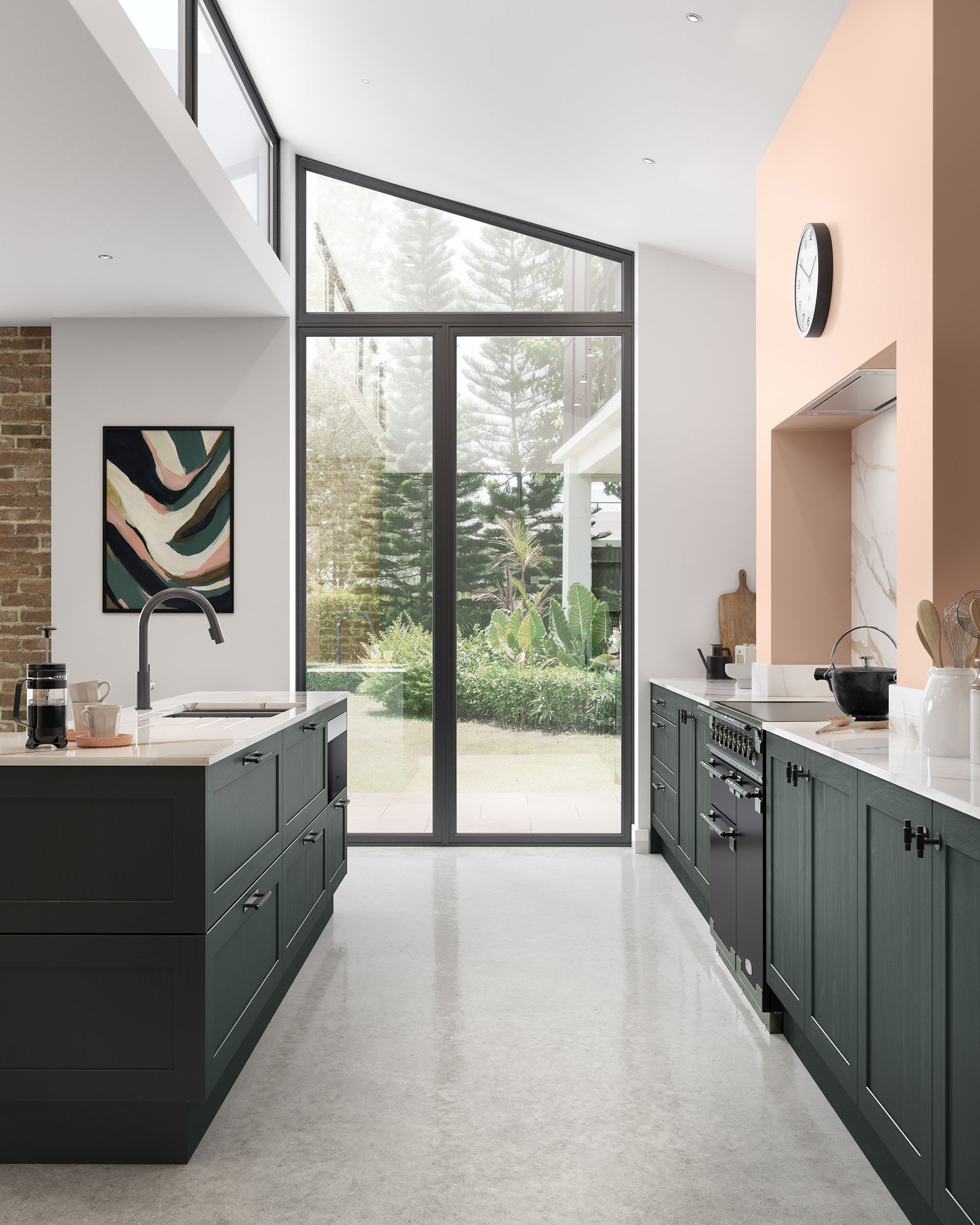 Modern kitchen with dark green cabinets, white countertops, and large glass doors opening to a garden.