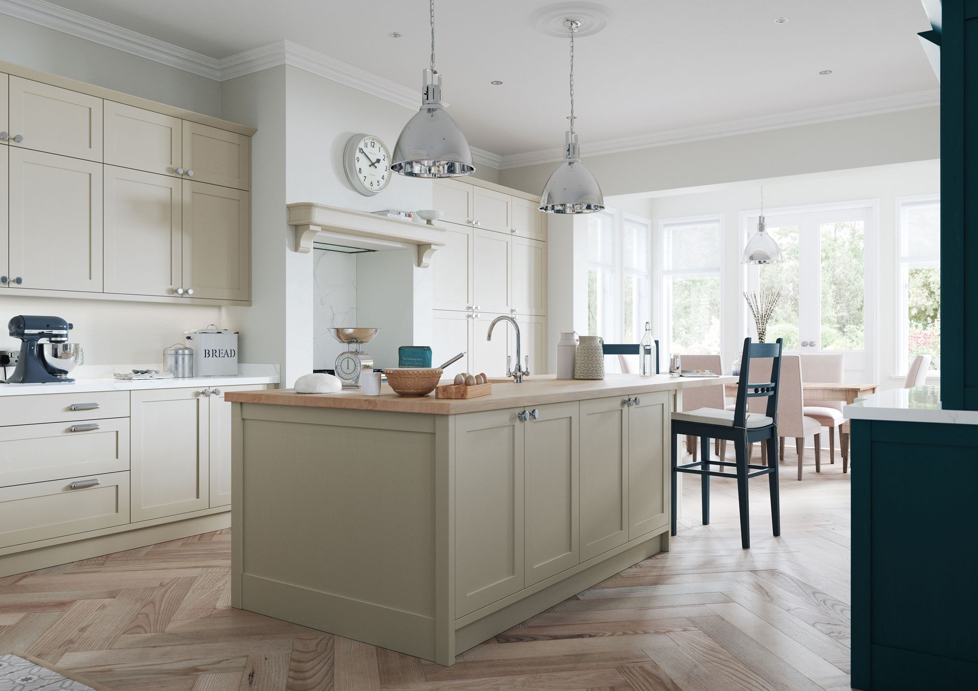 Bright white kitchen with large island, pendant lights, and dining area by sunlit windows.