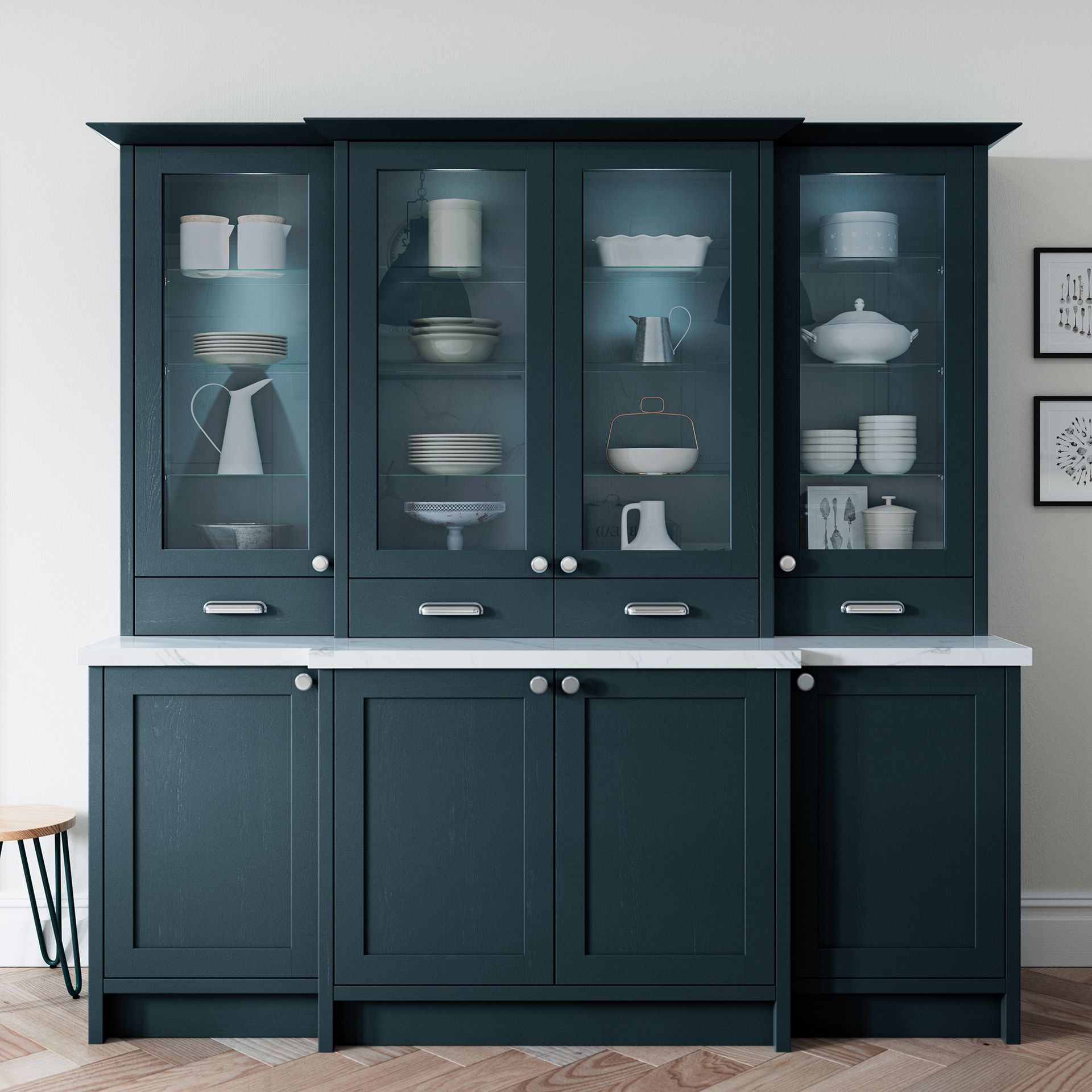Dark blue glass-front cabinet with dishes and teapots on a white wall backdrop