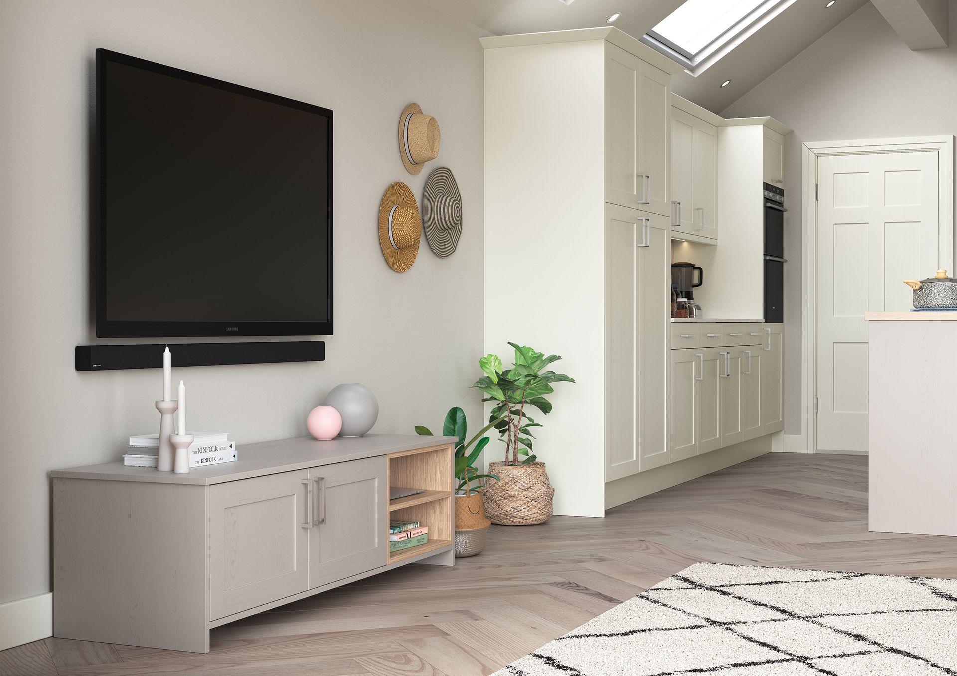 Bright living room with a wall-mounted TV, gray cabinet, plants, and a skylight opening to a kitchen.