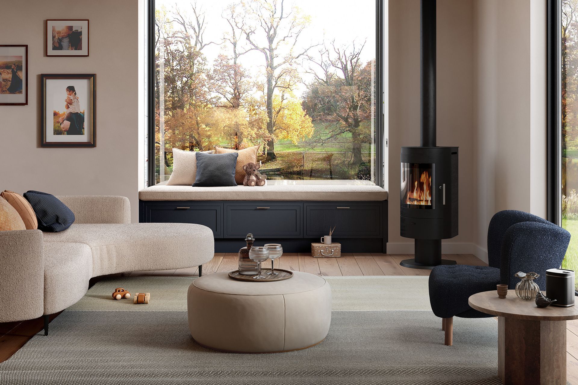 A modern living room with a curved sofa, round ottoman, window seat, and a lit fireplace, featuring cozy, neutral decor.
