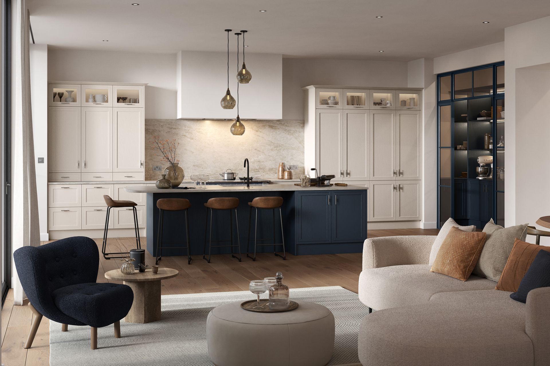 Modern open-plan kitchen and living room featuring a navy island, cream cabinetry, and cozy neutral seating.
