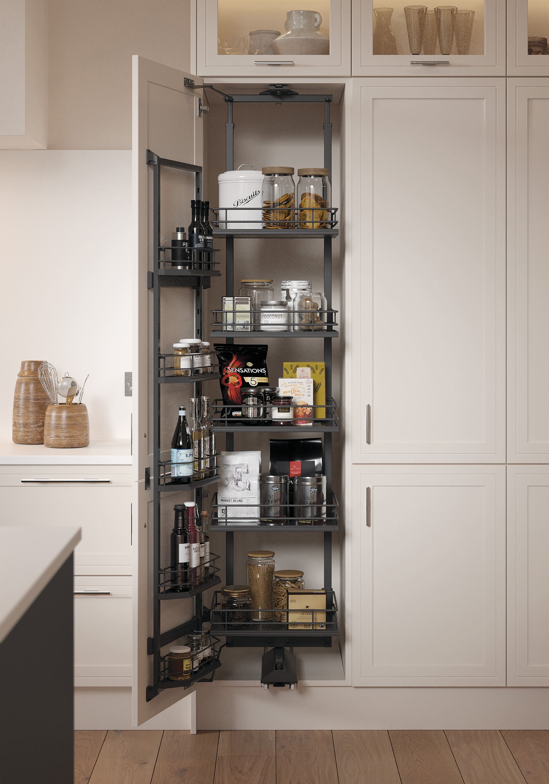 Tall, cream-colored kitchen pantry cabinet open to reveal a dark metal pull-out shelving unit filled with organized food.