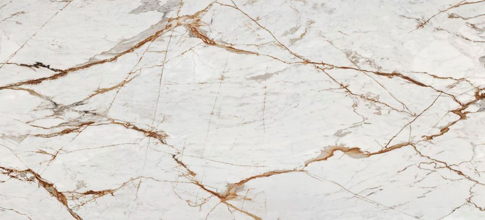 White marble surface featuring prominent, intricate golden-brown veining patterns throughout the stone.
