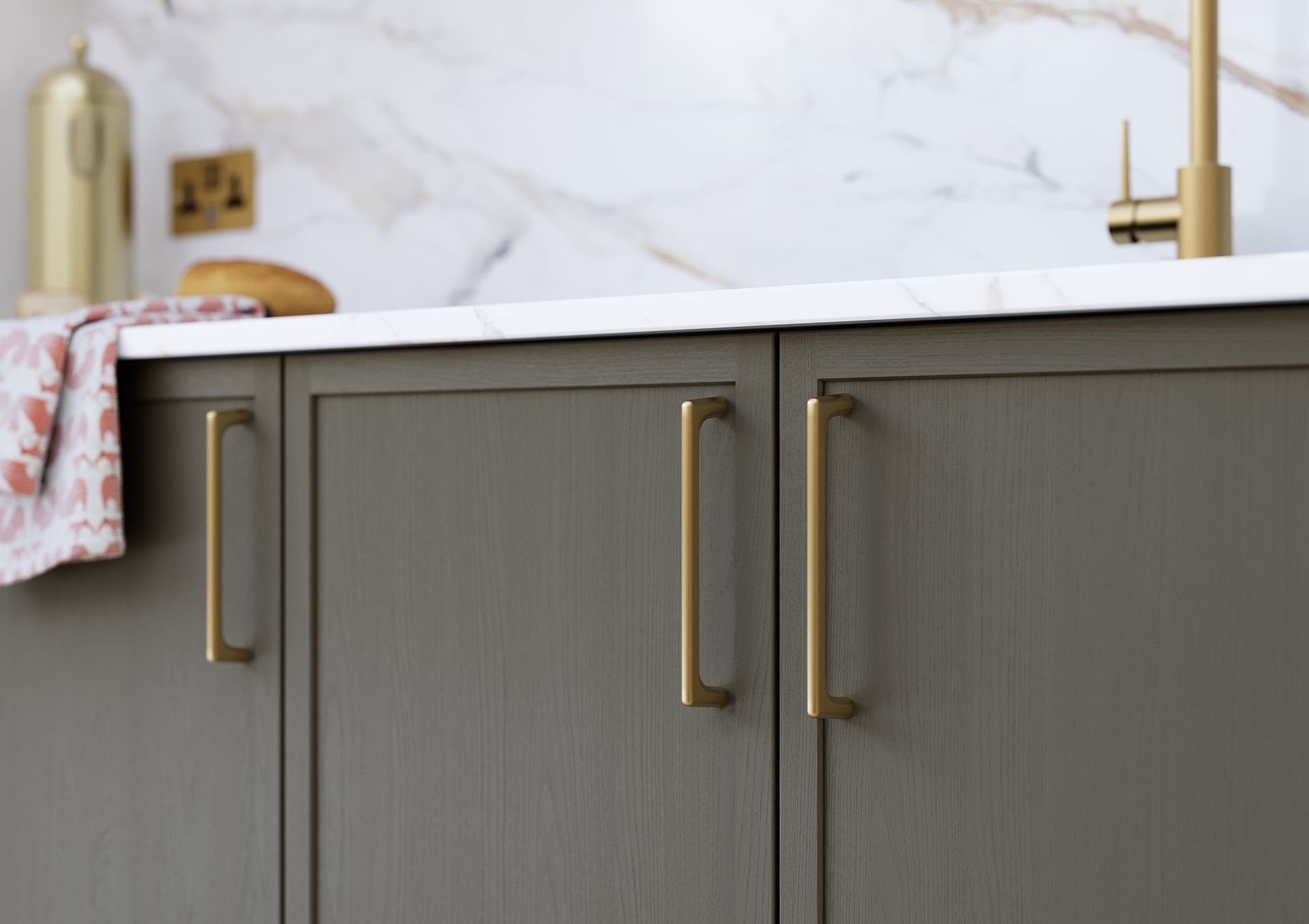 Dark gray kitchen cabinets with gold handles and white marble countertops.