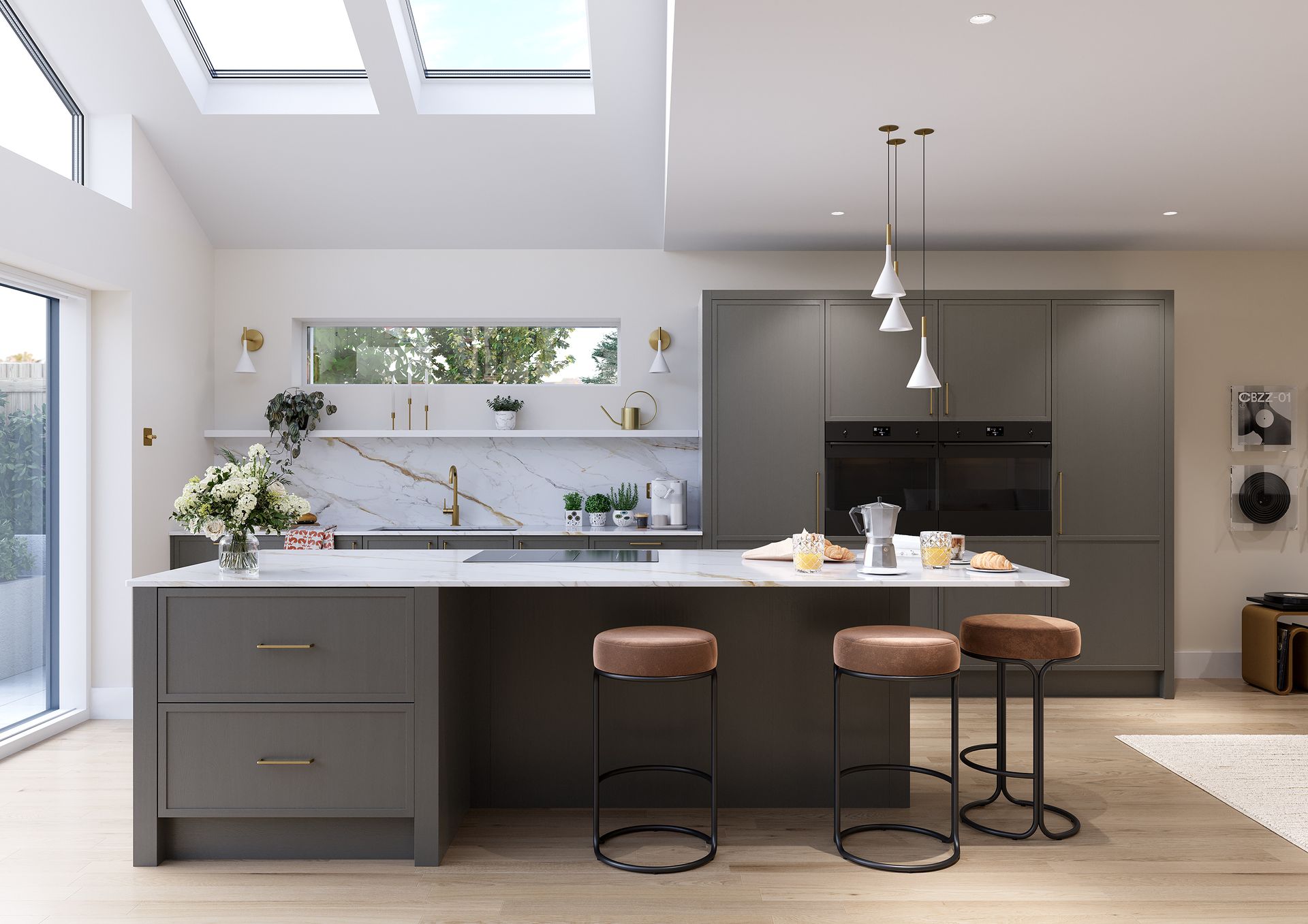A modern kitchen featuring a dark grey island with three stools, white countertops, and integrated wall ovens.